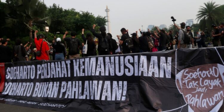Soeharto Tak Layak Dianugerahi Gelar Pahlawan Nasional Poster penolakan Soeharto diberi gelar Pahlawan Nasional. (Foto: Amnesty International Indonesia)